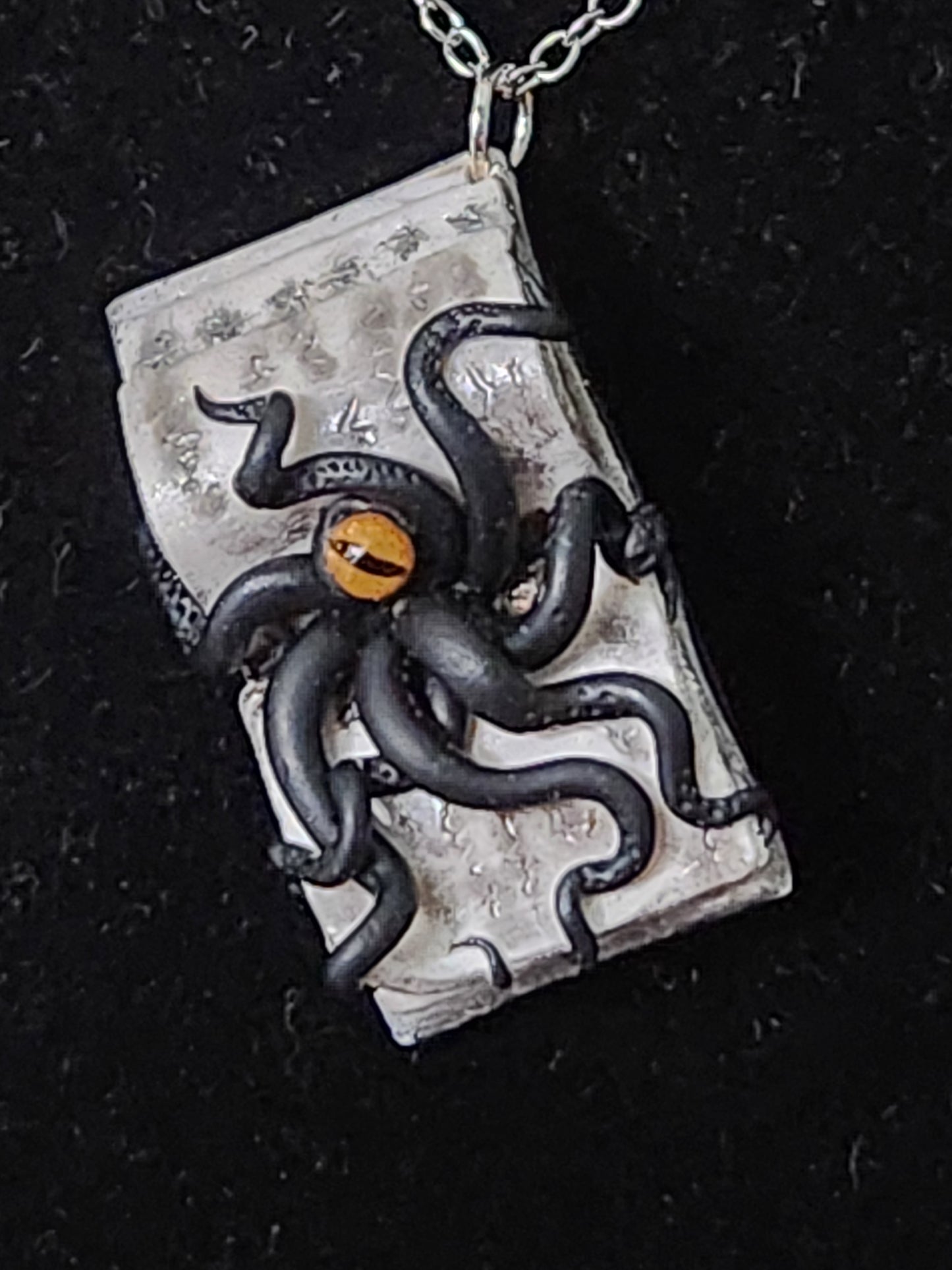 A6: Book with Creature pendant