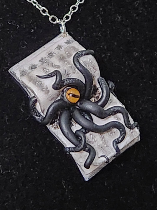 A6: Book with Creature pendant
