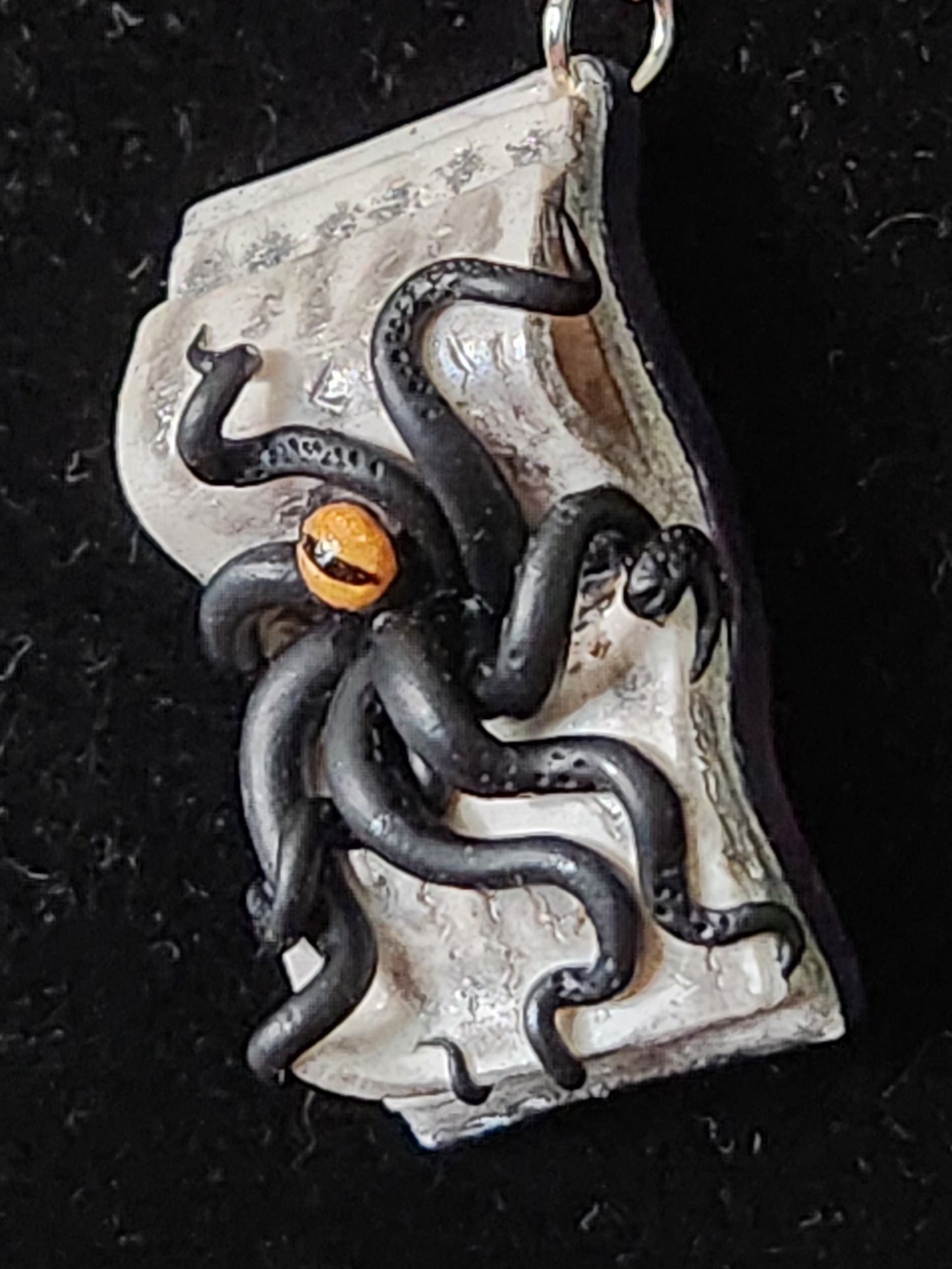 A6: Book with Creature pendant
